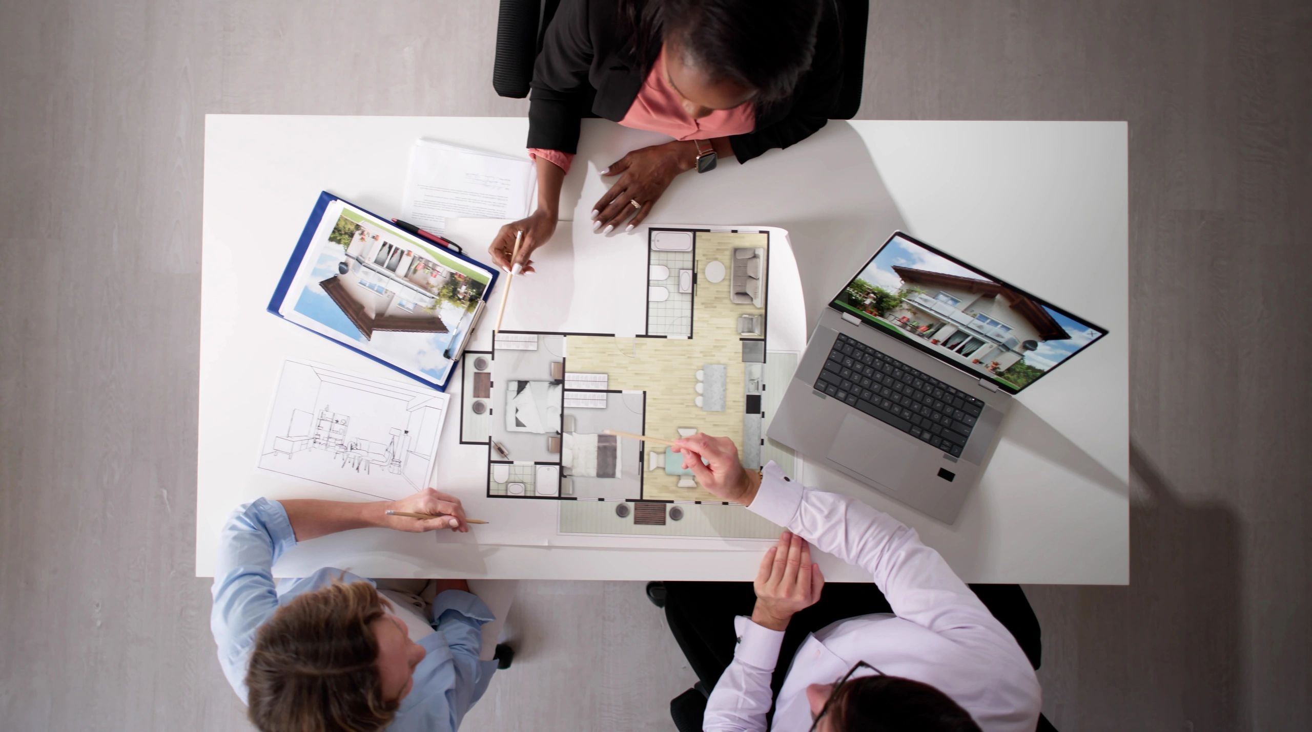 Professionals collaborating over floor plans